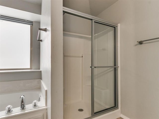 full bath featuring a shower stall and a bath