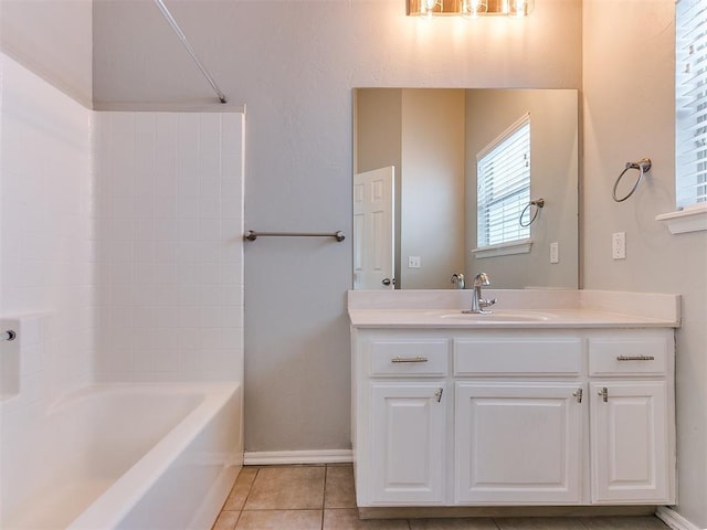 full bath with tile patterned flooring, baseboards, vanity, and shower / bath combination