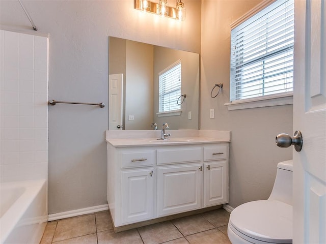 bathroom featuring toilet, tile patterned floors, vanity, baseboards, and bathtub / shower combination