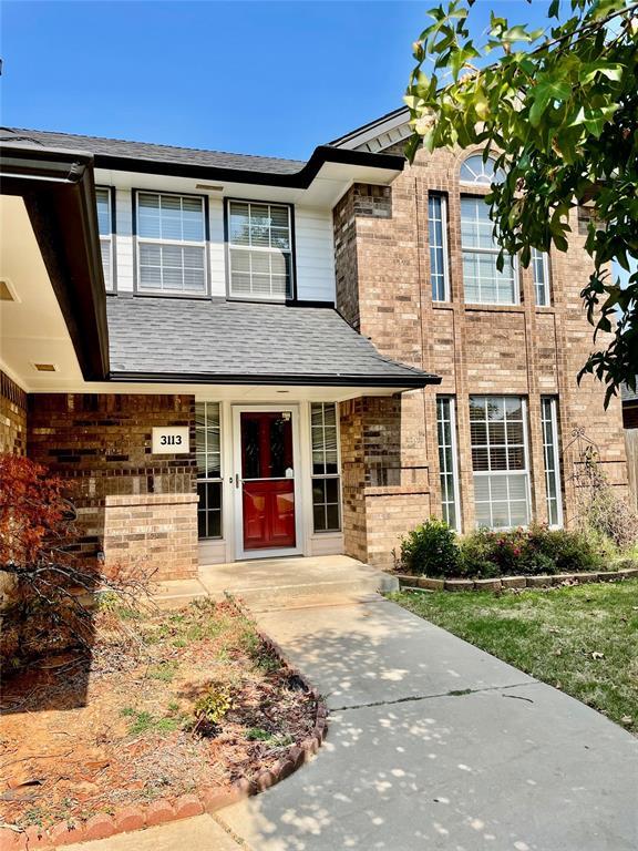 3113 SW 125th St, Oklahoma City, OK 73170 - view of front of home featuring brick siding, a shingled roof, and covered porch