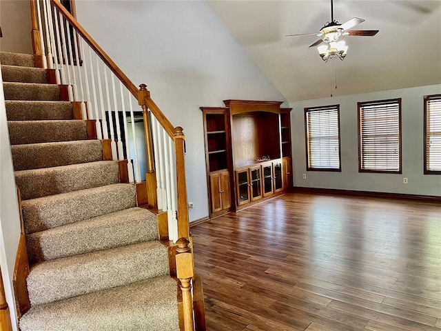 3113 SW 125th St, Oklahoma City, OK 73170 - unfurnished living room featuring a ceiling fan, stairs, wood finished floors, high vaulted ceiling, and baseboards