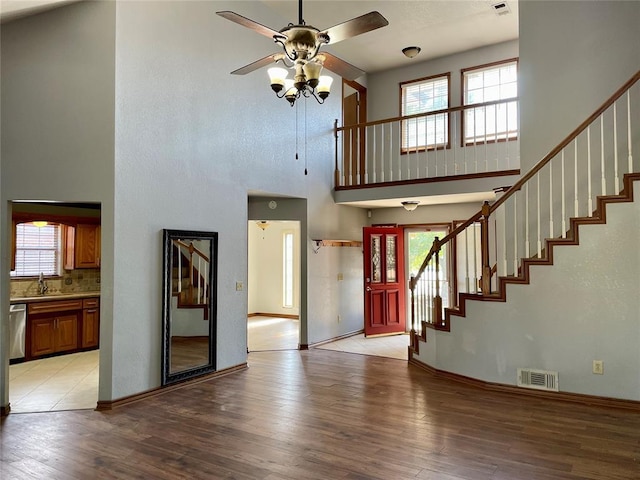 3113 SW 125th St, Oklahoma City, OK 73170 - foyer entrance featuring a high ceiling, ceiling fan, stairs, healthy amount of natural light, and light wood-type flooring