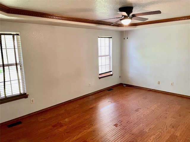 3113 SW 125th St, Oklahoma City, OK 73170 - spare room featuring ceiling fan, wood finished floors, baseboards, and a textured ceiling