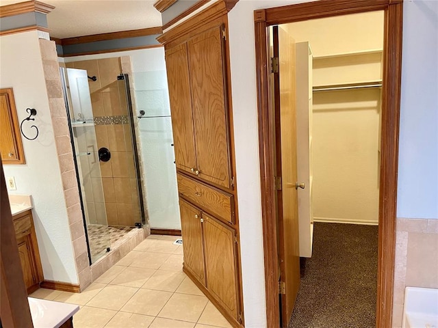 3113 SW 125th St, Oklahoma City, OK 73170 - bathroom featuring vanity, a shower stall, a spacious closet, baseboards, and ornamental molding