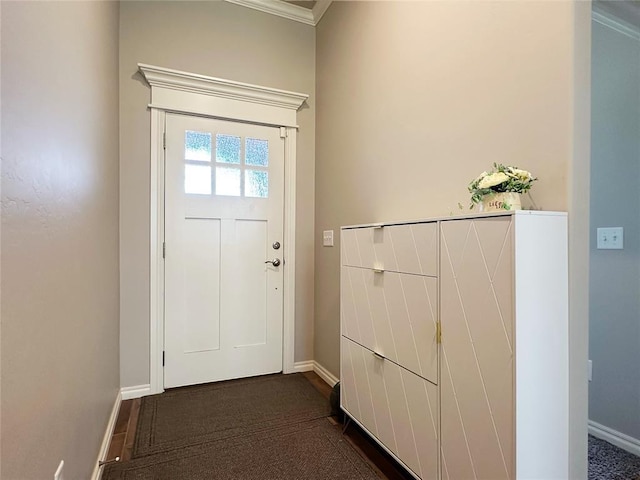 doorway to outside featuring baseboards and crown molding
