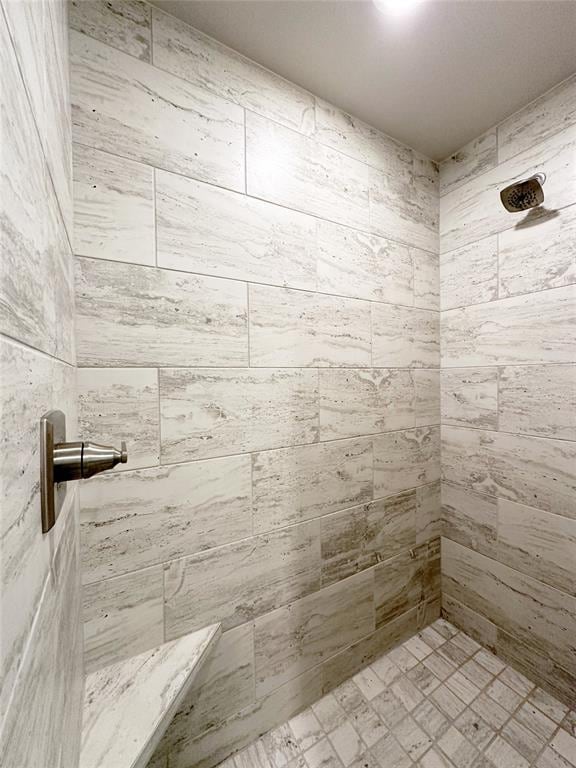 full bathroom with a tile shower