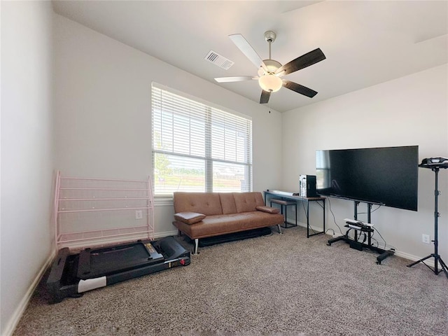 workout room featuring carpet, baseboards, and ceiling fan