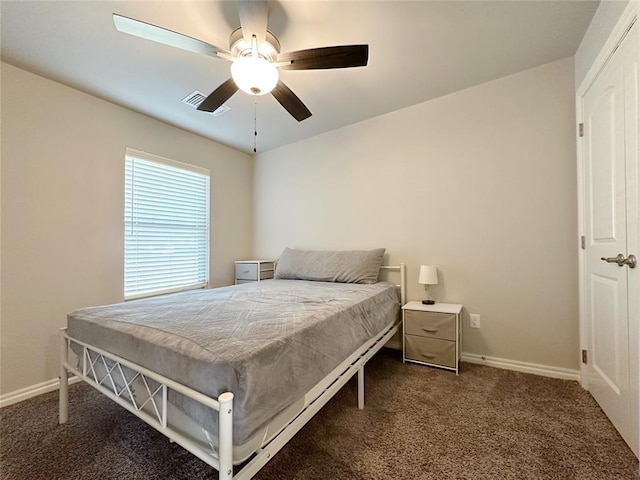 carpeted bedroom featuring baseboards and a ceiling fan