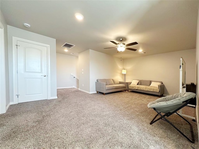 carpeted living area featuring ceiling fan, baseboards, and recessed lighting