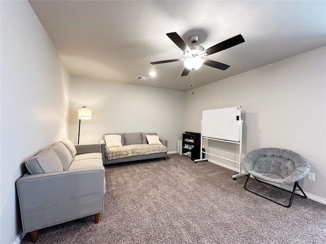living room with a ceiling fan, carpet floors, and baseboards