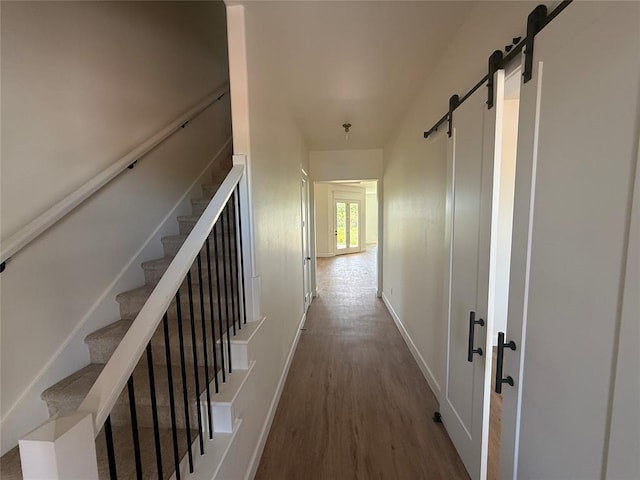 6921 Lake View Ct, Cashion, OK 73016 - corridor featuring a barn door, wood finished floors, baseboards, and stairs
