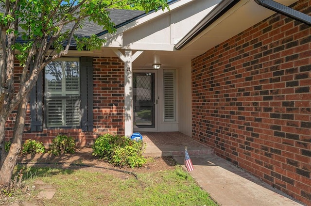 8720 Raven Ave, Oklahoma City, OK 73132 - property entrance with brick siding and roof with shingles