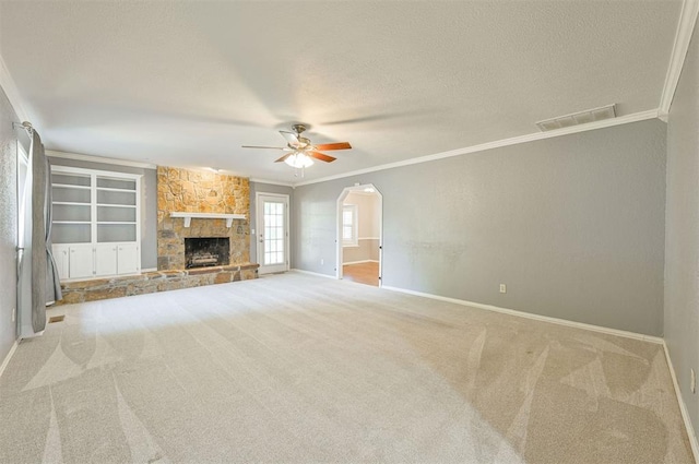 8720 Raven Ave, Oklahoma City, OK 73132 - unfurnished living room with ornamental molding, a ceiling fan, baseboards, carpet floors, and a textured ceiling