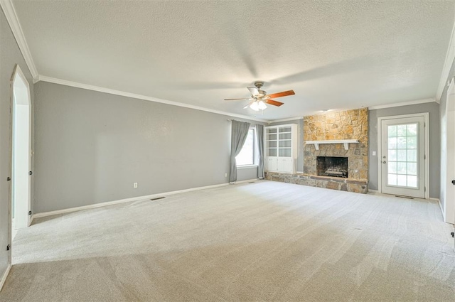 8720 Raven Ave, Oklahoma City, OK 73132 - unfurnished living room featuring ornamental molding, a ceiling fan, carpet flooring, a textured ceiling, and a fireplace