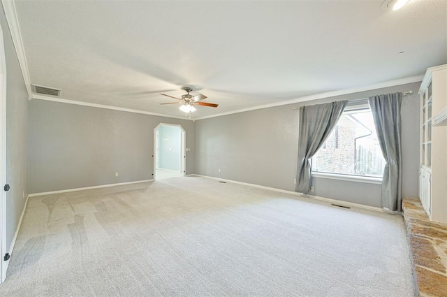 8720 Raven Ave, Oklahoma City, OK 73132 - empty room featuring ornamental molding, light colored carpet, ceiling fan, arched walkways, and baseboards