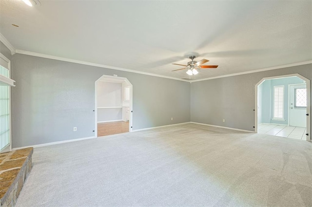 8720 Raven Ave, Oklahoma City, OK 73132 - empty room with arched walkways, light colored carpet, a ceiling fan, crown molding, and baseboards