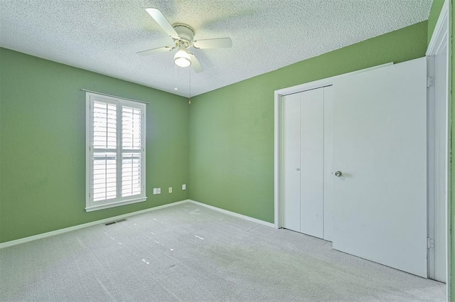 8720 Raven Ave, Oklahoma City, OK 73132 - unfurnished bedroom featuring a textured ceiling, a closet, carpet, ceiling fan, and baseboards