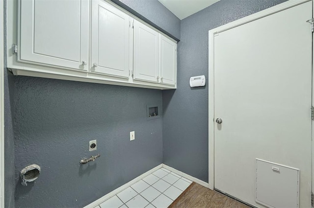 8720 Raven Ave, Oklahoma City, OK 73132 - laundry area featuring cabinet space, baseboards, a textured wall, hookup for a washing machine, and wood finished floors
