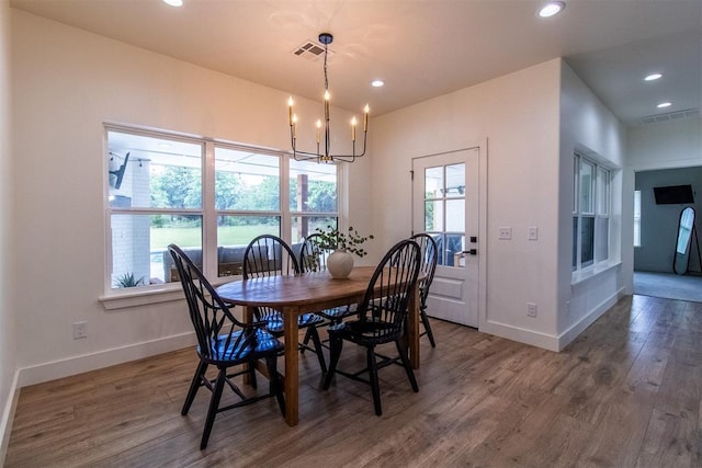 dining space featuring baseboards, wood finished floors, recessed lighting, and a chandelier