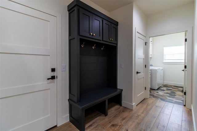 mudroom featuring washing machine and clothes dryer, light wood-style floors, and baseboards