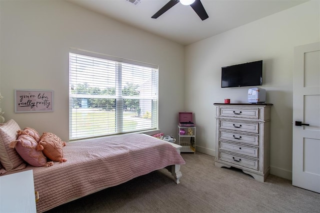 bedroom featuring light colored carpet, ceiling fan, and baseboards
