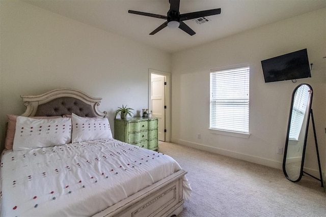 bedroom with light carpet, baseboards, and ceiling fan