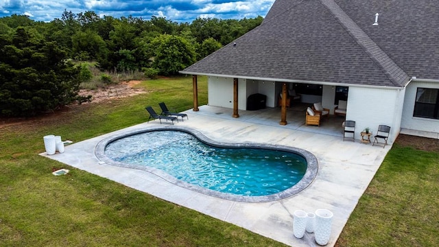 outdoor pool with a patio and a lawn