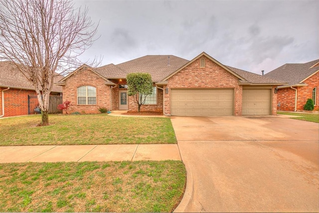 5608 Bent Creek Dr, Oklahoma City, OK 73135 - view of front of home with a garage, brick siding, concrete driveway, and roof with shingles