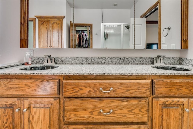 5608 Bent Creek Dr, Oklahoma City, OK 73135 - bathroom featuring double vanity, a stall shower, and a walk in closet
