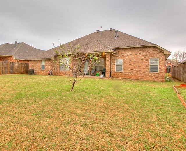 5608 Bent Creek Dr, Oklahoma City, OK 73135 - back of property featuring roof with shingles, brick siding, and a patio area