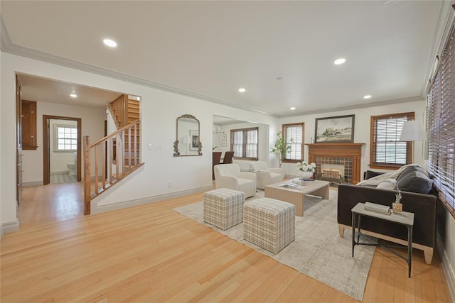 2650 NW 25th St, Oklahoma City, OK 73107 - living room featuring wood finished floors, a fireplace, stairway, crown molding, and recessed lighting