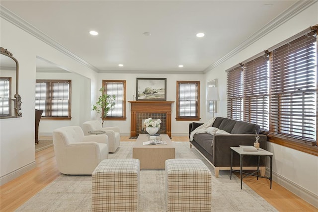 2650 NW 25th St, Oklahoma City, OK 73107 - living room featuring baseboards, light wood-style floors, crown molding, recessed lighting, and a tile fireplace
