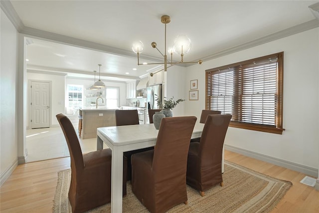 2650 NW 25th St, Oklahoma City, OK 73107 - dining room featuring a chandelier, light wood finished floors, crown molding, baseboards, and recessed lighting