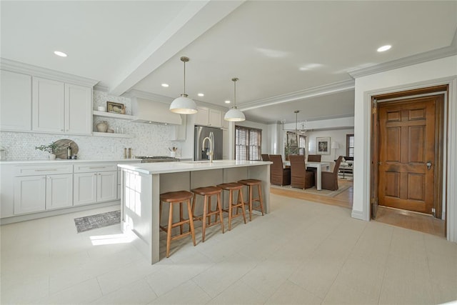 2650 NW 25th St, Oklahoma City, OK 73107 - kitchen with stainless steel fridge with ice dispenser, light countertops, backsplash, open shelves, and white cabinets
