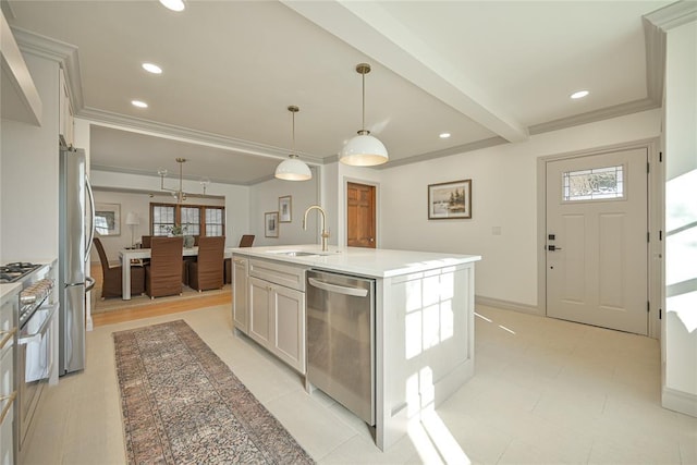 2650 NW 25th St, Oklahoma City, OK 73107 - kitchen with stainless steel appliances, a sink, a center island with sink, decorative light fixtures, and crown molding