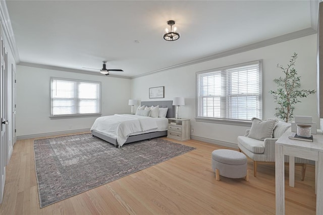2650 NW 25th St, Oklahoma City, OK 73107 - bedroom with ornamental molding, multiple windows, light wood-style floors, baseboards, and ceiling fan