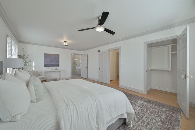 2650 NW 25th St, Oklahoma City, OK 73107 - bedroom with crown molding, light wood-type flooring, baseboards, a ceiling fan, and ensuite bath