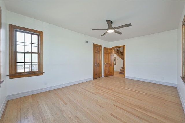 2650 NW 25th St, Oklahoma City, OK 73107 - unfurnished room featuring a ceiling fan, light wood-style flooring, baseboards, and stairs