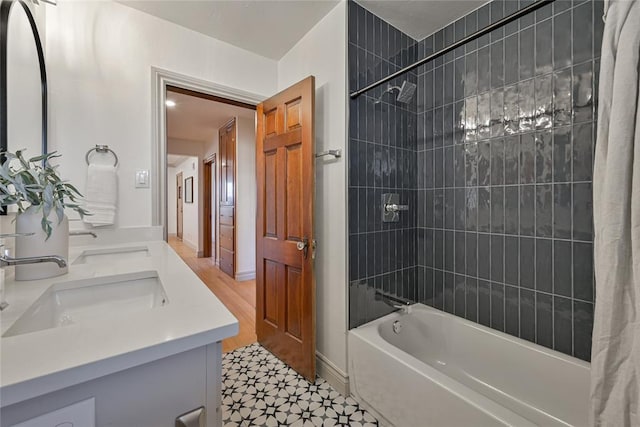 2650 NW 25th St, Oklahoma City, OK 73107 - full bath with double vanity, shower / bathtub combination with curtain, tile patterned floors, and baseboards