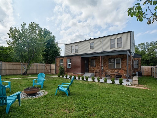 2650 NW 25th St, Oklahoma City, OK 73107 - rear view of property with an outdoor fire pit, cooling unit, and a patio