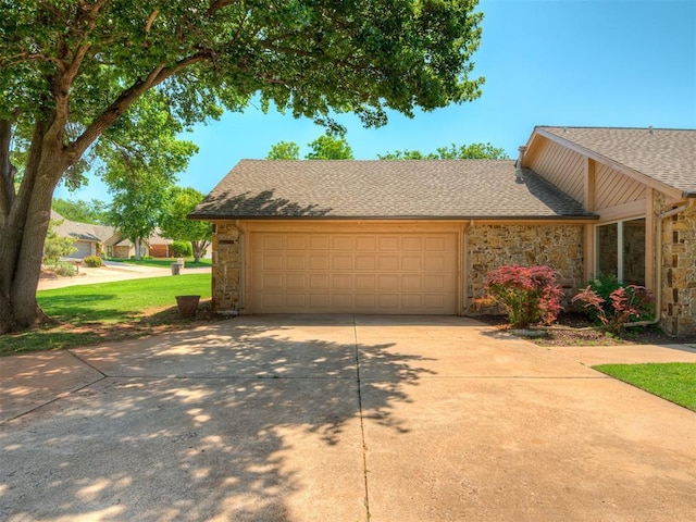 4400 Windsong Way, Oklahoma City, OK 73120 - view of front of house featuring stone siding, driveway, roof with shingles, and an attached garage