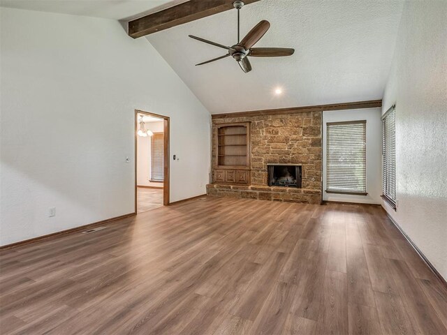 4400 Windsong Way, Oklahoma City, OK 73120 - unfurnished living room featuring ceiling fan, beamed ceiling, wood finished floors, built in shelves, and baseboards