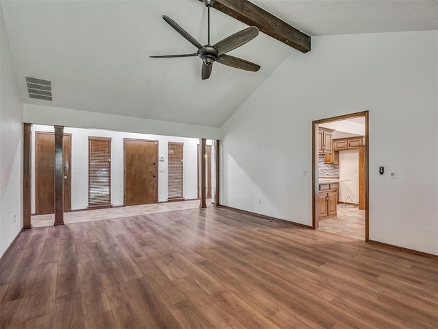 4400 Windsong Way, Oklahoma City, OK 73120 - unfurnished bedroom featuring beam ceiling, wood finished floors, ensuite bathroom, high vaulted ceiling, and baseboards