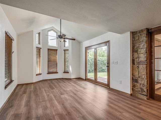 4400 Windsong Way, Oklahoma City, OK 73120 - unfurnished living room featuring a ceiling fan, wood finished floors, vaulted ceiling, a textured ceiling, and baseboards