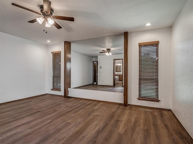 4400 Windsong Way, Oklahoma City, OK 73120 - unfurnished room featuring a ceiling fan, a textured wall, wood finished floors, baseboards, and a textured ceiling