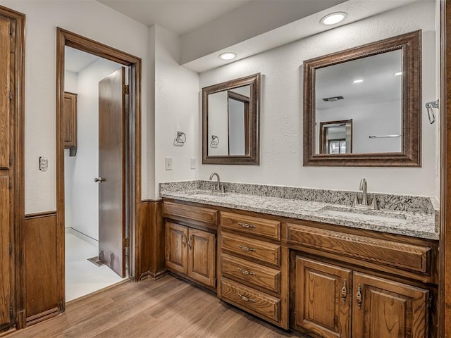 4400 Windsong Way, Oklahoma City, OK 73120 - full bathroom with double vanity, wood finished floors, and wainscoting
