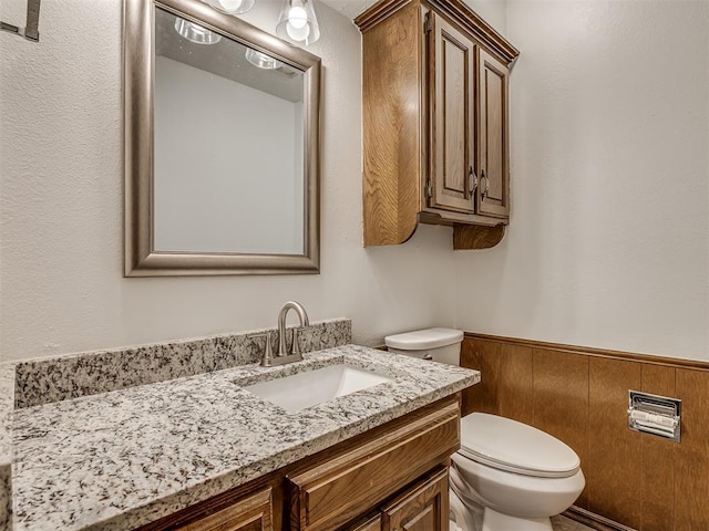 4400 Windsong Way, Oklahoma City, OK 73120 - half bathroom featuring toilet, vanity, and a wainscoted wall