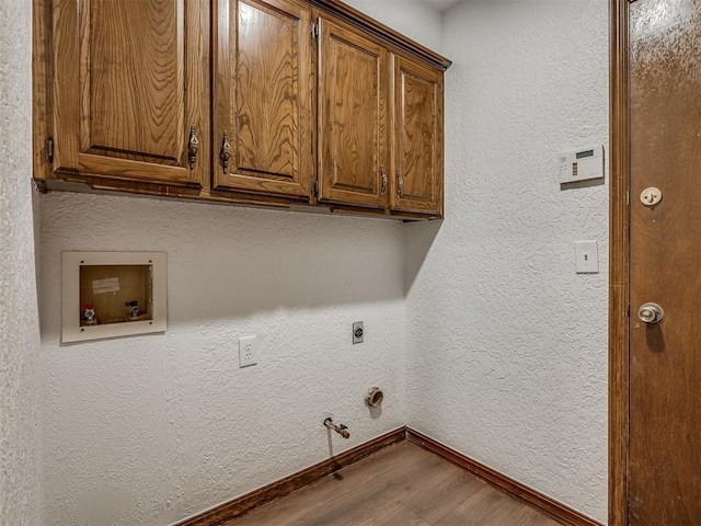 4400 Windsong Way, Oklahoma City, OK 73120 - washroom with wood finished floors, electric dryer hookup, cabinet space, baseboards, and hookup for a washing machine