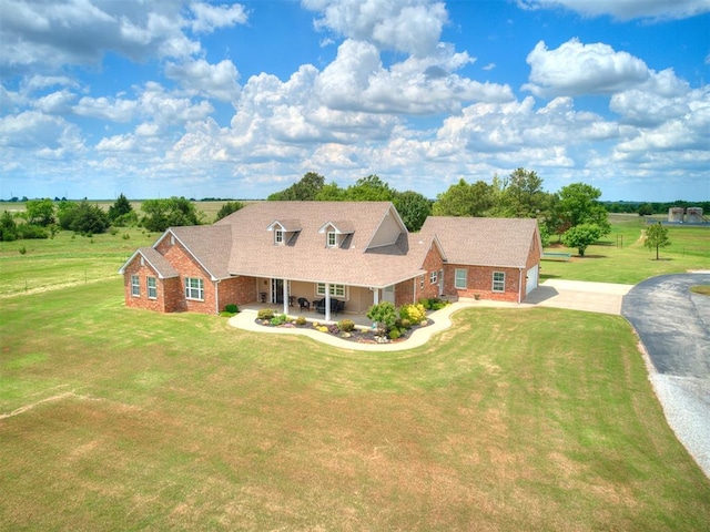 cape cod-style house with brick siding, driveway, a front lawn, a porch, and a garage