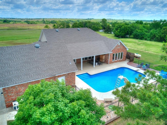 view of pool featuring a patio and a water slide